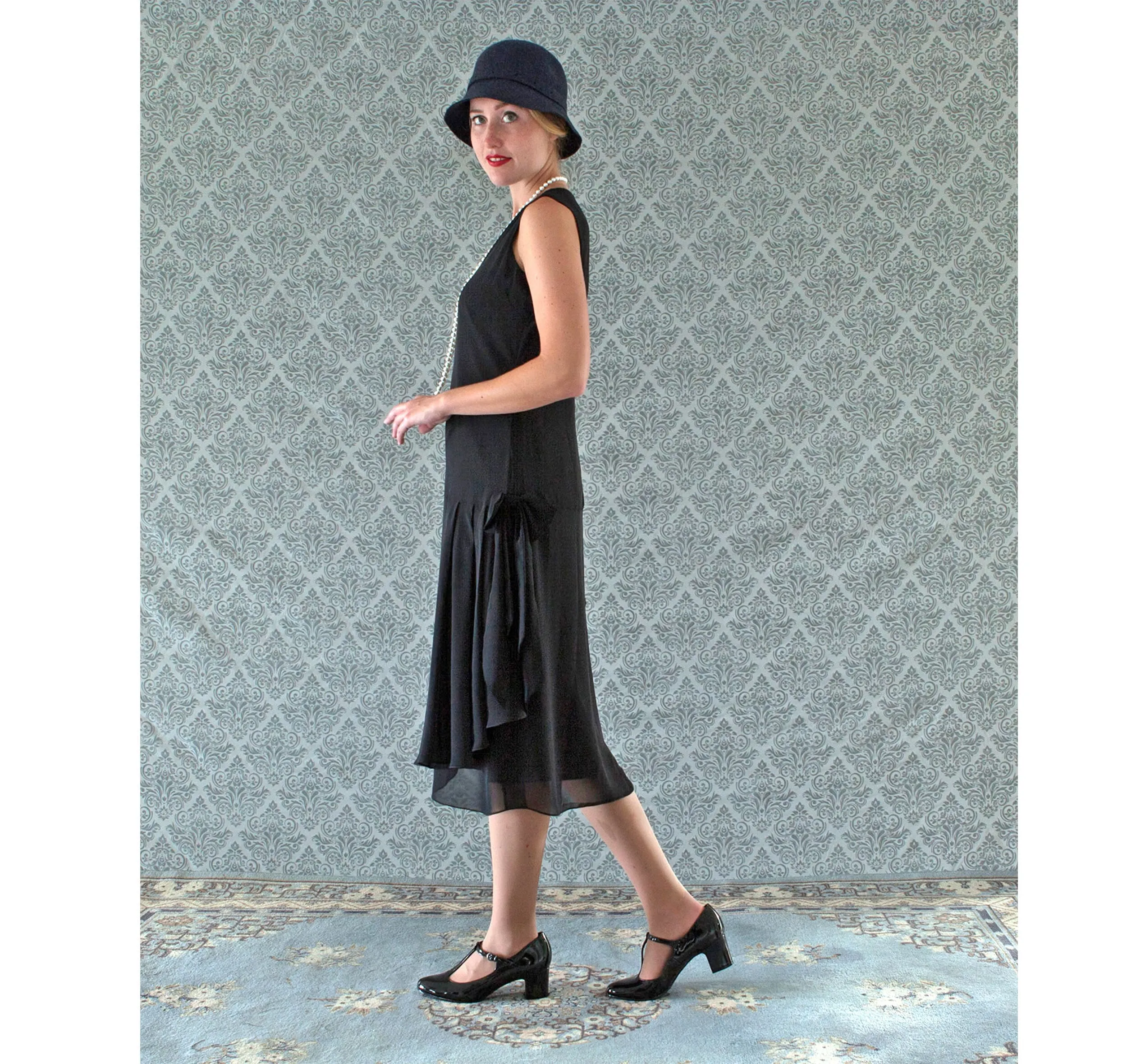 V-neck black flapper dress with drape and bow